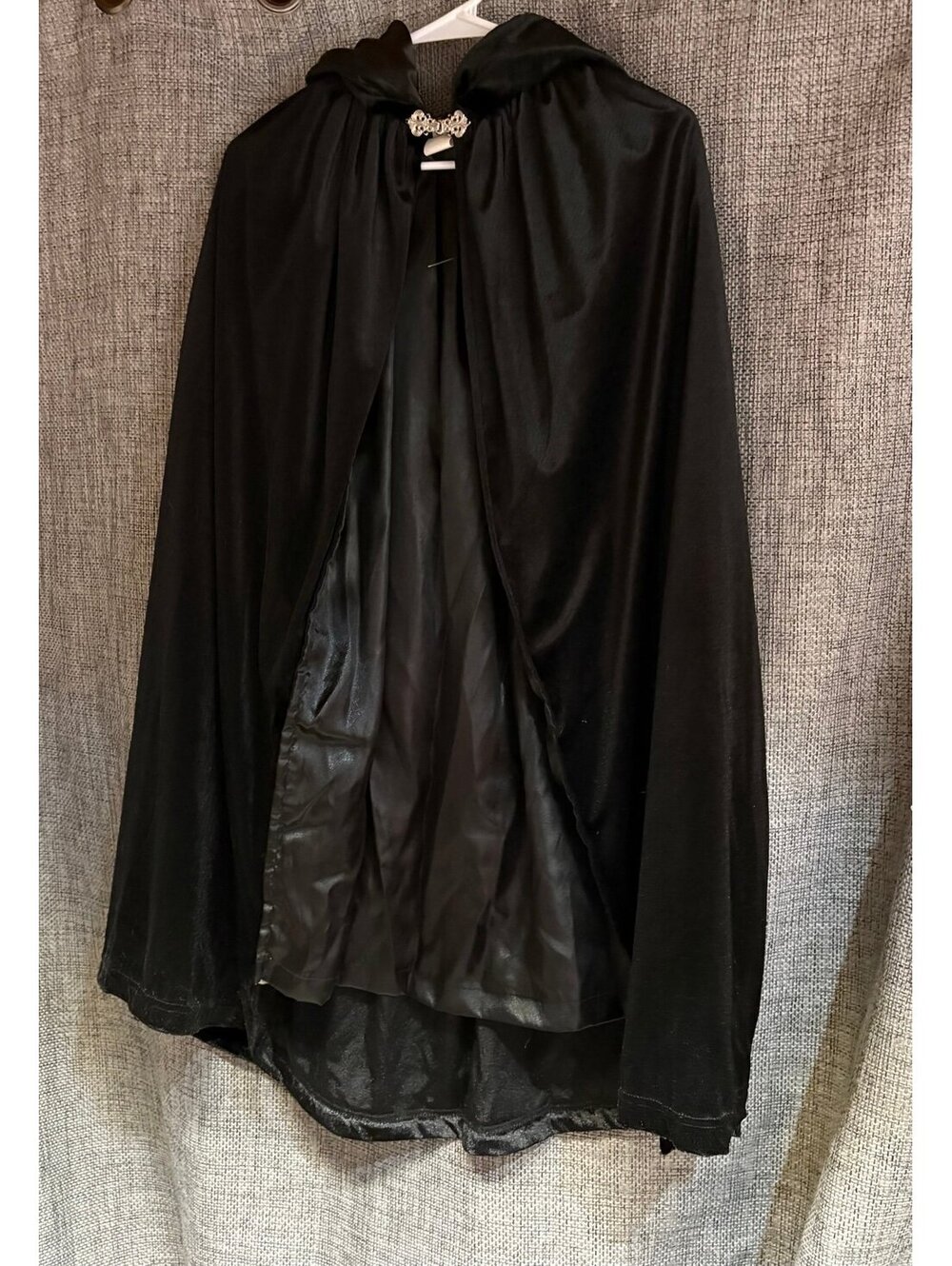 black hooded costume cloak featuring a velvet like finish